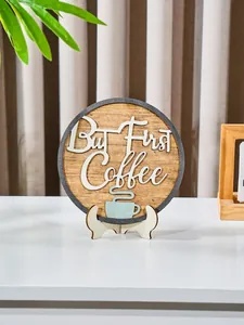 Close-up of 'But First Coffee' round wooden plaque on a minimalist white stand