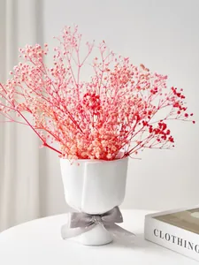 Close-up detail of a Nordic white bouquet-shaped resin vase with pink dried flowers