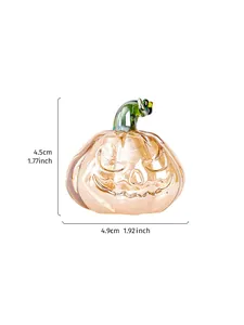 Detailed view of a hand-blown glass Halloween pumpkin ornament with size markers