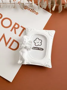 Detail of white mini angel resin photo frame in vintage European style home decoration
