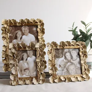 Detailed view of gold ginkgo leaf resin photo frames in various sizes for home decor.