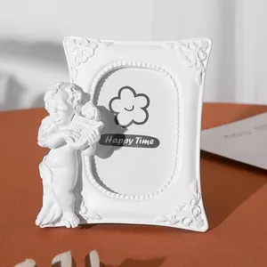 Detail view of white vintage angel resin photo frame with harpist figurine decor