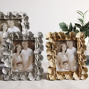 Detail of ginkgo leaf resin photo frame with antique gold and silver finishes