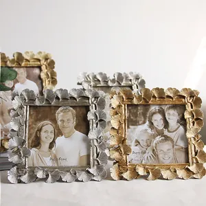 Detailed macro view of vintage gold and silver ginkgo leaf patterned resin photo frames