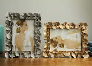 Detail view of ornate ginkgo leaf resin photo frames in gold and silver finish