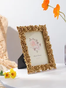 Close-up of vintage gold photo frame with intricate rose carvings in 5x7 size
