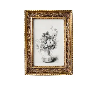 Elegant antique gold resin photo frame with intricate floral carvings for home decor