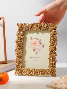 Detailed view of ornate golden rose carvings on a vintage 5x7 tabletop photo frame