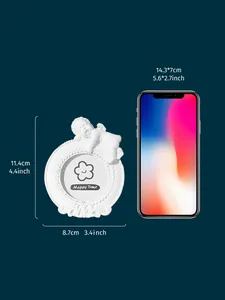 Detailed size comparison of white mini angel resin photo frame with a smartphone