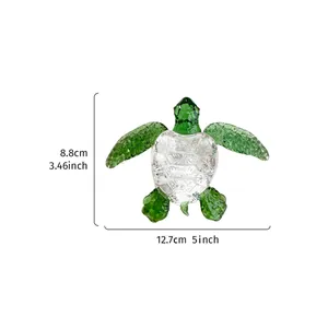 Transparent glass sea turtle ornament with green body showing dimensions 12.7cm by 8.8cm