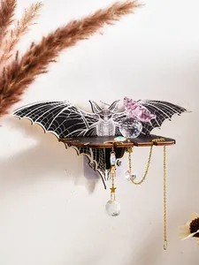 Detail of a bat-shaped wooden wall shelf with hanging crystal suncatchers for Halloween décor.