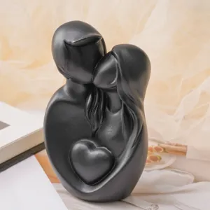 Minimalist black artistic couple figurine embracing with a heart for home decoration