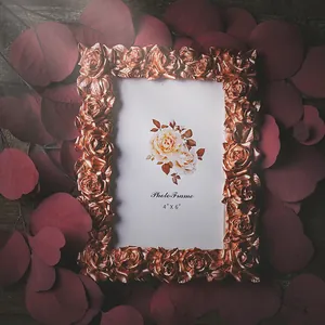 Elegant vintage rose gold floral photo frame for 4x6 inch pictures on dark leaves