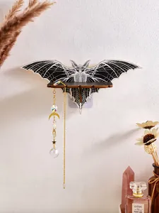 Detailed view of a bat-shaped wooden wall shelf featuring hanging crystal moon pendants