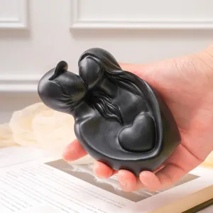 Modern minimalist black resin couple embrace sculpture with heart detail for home decor