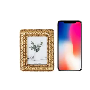 Elegant golden woven resin photo frame home decor shown with smartphone for size