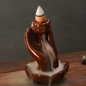 Bruciatore di incenso a riflusso in resina mano di Buddha Zen con base a loto ed fumo