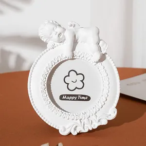 European vintage style white resin round photo frame with a sleeping angel statue
