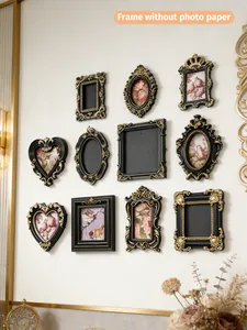 Collection of vintage mini black and gold magnetic photo frames on a white gallery wall