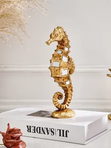 Macro view of a luxury golden resin seahorse figurine with decorative mirror inlays