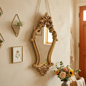 Ornate vintage golden wall-mounted mirror with relief carving for elegant home decor