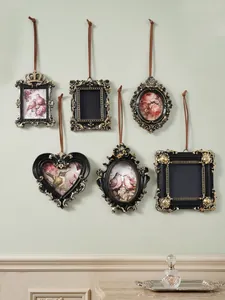 Detailed view of vintage European-style mini black and gold hanging wall photo frames