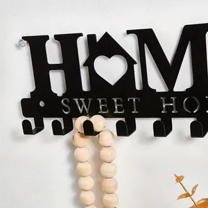 Close-up detail of black metal Home Sweet Home decorative wall hook with heart design