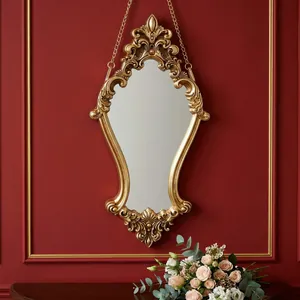 Ornate gold carved wall mirror in vintage European luxury style for elegant home decor.