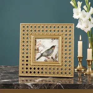 Detailed view of a square gold resin photo frame with an elegant woven cane texture.