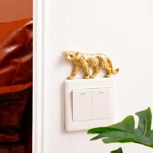 Luxury golden leopard resin wall sticker decoration mounted above a modern white light switch