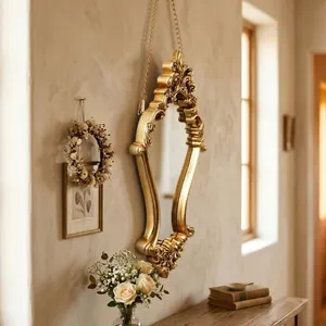 Elegant vintage European gold carved wall mirror hanging in a cozy luxury room setting