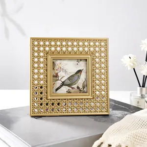 Close-up of golden square resin photo frame with intricate rattan-woven texture