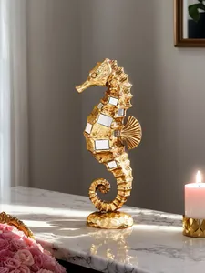 Close-up of golden seahorse resin figurine with mirrored inlays on marble surface
