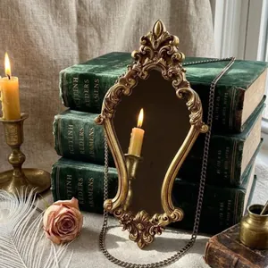 Detailed view of an ornate vintage gold relief carved mirror with elegant baroque patterns.