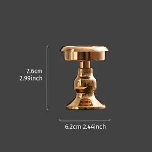 Gold mini metal candlestick with dimensions 7.6cm height and 6.2cm width.