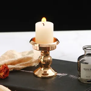 Detail of French minimalist mini gold metal candle holder for romantic home decor