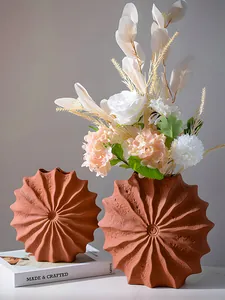 Macro view of pleated terracotta resin vases with elegant white artificial flowers