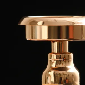 Macro view of a glossy gold metallic candlestick showing premium reflective finish.