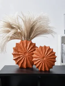 Minimalist orange conch resin vase with pleated texture and dried flower decor