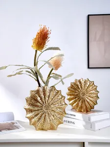 Exquisite detail of modern resin shell-shaped golden vase with textured handmade finish