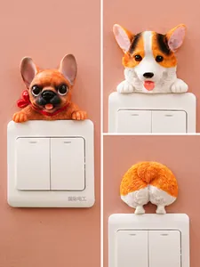 Detail view of 3D resin dog switch stickers featuring Corgi and French Bulldog styles