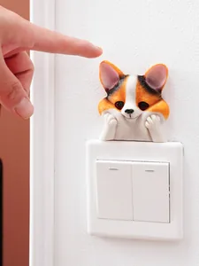 Close-up of 3D resin Corgi dog wall sticker decoration peeking over a light switch