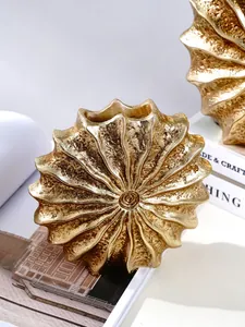 Detail view showing the intricate gold texture of the conch resin vase ornament