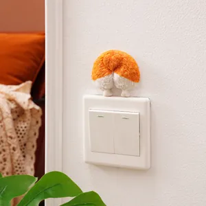 Close-up of a cute 3D resin Corgi butt decorative sticker on a white light switch.