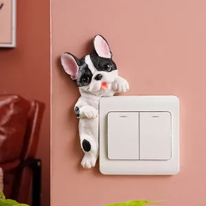 Realistic 3D resin French Bulldog figurine peaking from behind a white light switch