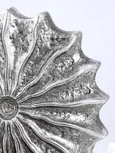 Close-up of modern silver conch resin vase showing the detailed handcrafted metallic texture