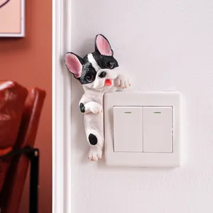 3D resin French Bulldog wall switch decoration in a cute peeking pose on white wall.