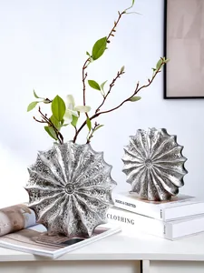 Exquisite silver seashell resin vases with textured finish in a modern lifestyle scene