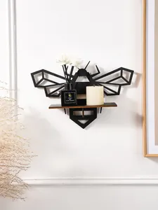 Detailed view of the geometric black wooden bee wall shelf with diffuser and candle