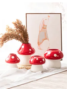 Detailed view of creative red and white mushroom resin vases for home decoration